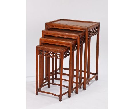 Nest of four Canton Chinese tables, with scroll pierced friezes, on turned legs and stretchers, the largest 45cm wide (4)