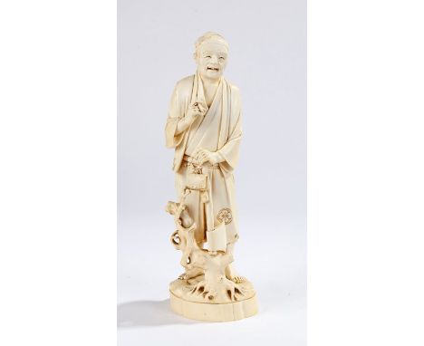 Fine Japanese Meiji period ivory Okimono, the one piece carved figure of a man smoking standing above his axe and a tree stum