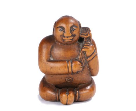 Japanese Meiji period netsuke, the wood netsuke depicting a naked seated boy holding a lotus, with retractable penis, 3cm hig