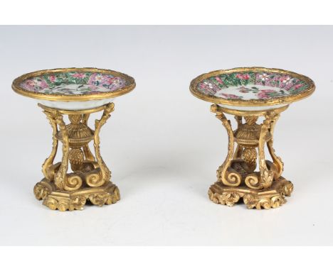 A pair of ormolu mounted Chinese export style famille rose porcelain saucers, 19th century, each circular fluted saucer, prob