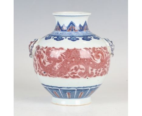 A Chinese underglaze blue and copper red porcelain vase, mark of Qianlong and probably of the period, the compressed ovoid bo