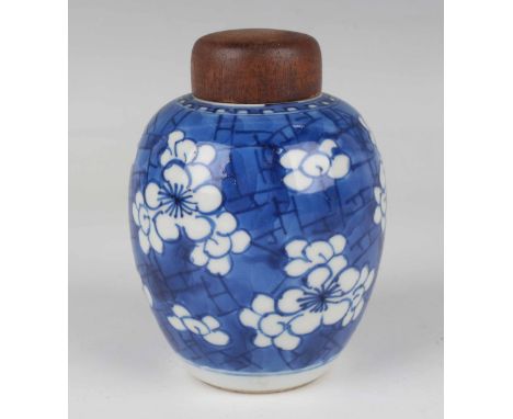 A Chinese blue and white export porcelain tea caddy, Kangxi period, of ovoid form, painted with prunus on a cracked ice groun