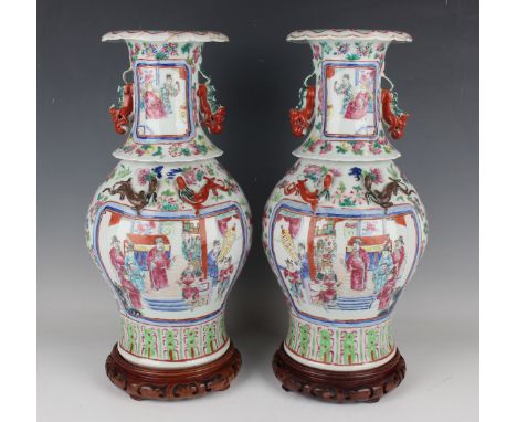 A pair of Chinese famille rose porcelain vases, mid to late 19th century, each baluster body and flared neck painted with opp