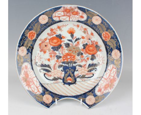 A Continental Japanese Imari style porcelain shaving bowl, late 19th century, the centre painted and gilt with flower charged