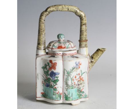 A Chinese famille verte export porcelain teapot and cover, Kangxi period, the body painted with panels of flowers and rockwor