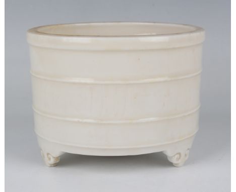 A Chinese blanc-de-Chine porcelain censer, Kangxi period, of cylindrical form with three horizontal ribs and a faintly impres