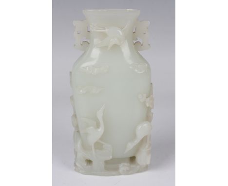 A Chinese pale celadon/white jade vase, Qing dynasty, of flattened spade form, the short flared neck flanked by a pair of car