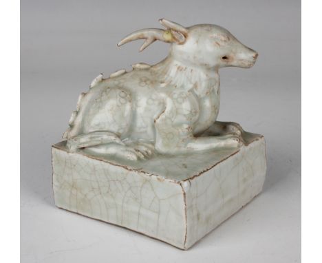 A Chinese Qingbai type porcelain seal, the cube base surmounted with a recumbent deer, covered in a pale bluish crackled glaz