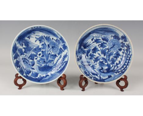 A pair of Chinese blue and white porcelain circular bowls, Qing dynasty, each interior painted with a pair of fenghuang and p