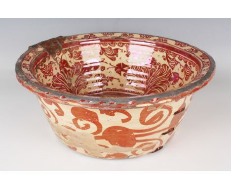 A Hispano-Moresque lustre basin, late 17th/early 18th century of steep-sided circular form with notched everted rim, decorate