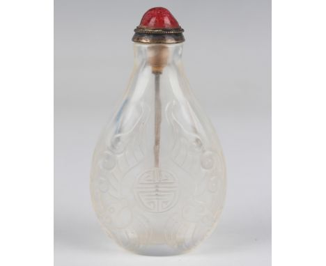 A Chinese rock crystal snuff bottle, Qing dynasty, of flattened pear form, the body carved in low relief to each side with a 