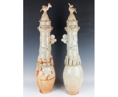 A pair of large Chinese celadon glazed funerary vases and covers, Song dynasty style but later, each ovoid body below a narro