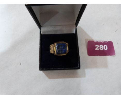 An Islamic gilt metal blue stone intaglio ring. Size K½'