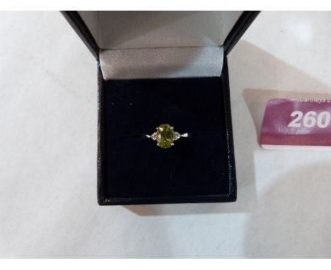 An 18ct yellow sapphire and diamond three stone ring. 2.8g gross. Size N½