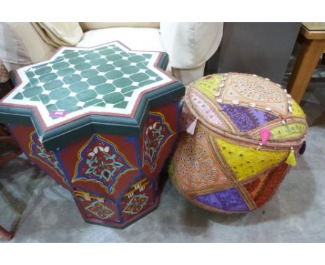 An Indian pouffe decorated with cowrie shells and a painted Moroccan occasional table