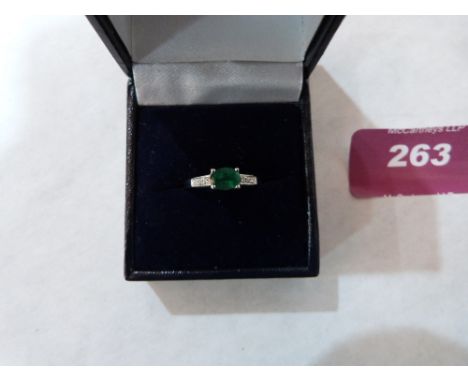 A 9ct emerald and diamond ring. 1.9g gross. Size Q