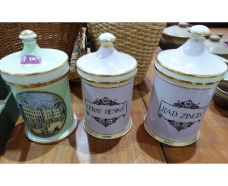 Three ceramic apothecary jars and covers, one decorated with a view of Buckingham Palace, the other marked 'RAD ZINGIB' or 'C