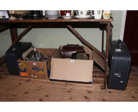 Two boxes with oak clock, barometer, linen, EP and Stainless wares, suitcases, etc