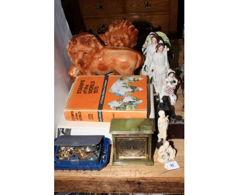 Staffordshire lions and figures, album of Royal Wedding first day covers, Elliot mantel clock, carved figure, etc