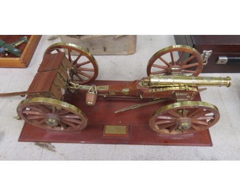 A brass and hardwood model of a field gun and gun carriage on base