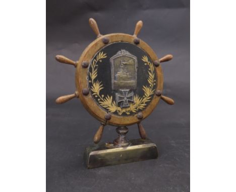 A WWI Austro Hungarian trench art model of a ships wheel with central cap badge and iron cross 
