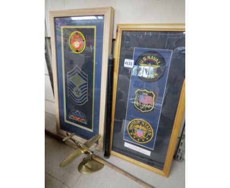 A pair of United States shoulder badge displays, a brass Spitfire model on stand, and a riding whip with West Somerset Regt. 