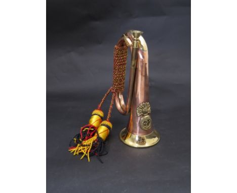 A 20th Century brass and copper bugle with 23rd Royal Welsh Fusiliers badge together with rope and tassel 