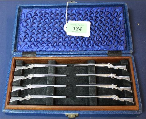 A cased set of eight 'butt markers' modelled as hammer shotguns (numbers on their butts)