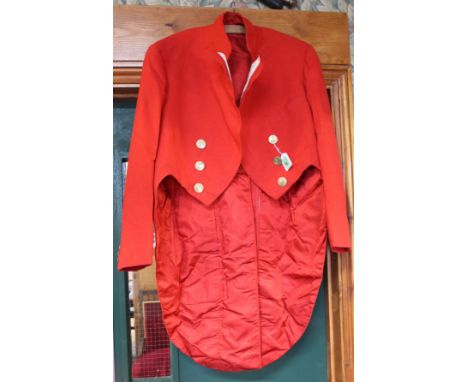 A vintage hunting jacket with monogrammed brass buttons