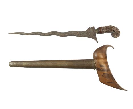 A GOOD MALAYAN KRIS, 19th century, with 14.5 (37cm) wavy blade and the wooden hilt profusely carved with scrolling foliage an