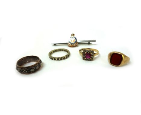 A 9ct yellow gold and red carnelian signet ring, size J, 2.3g gross, a gold silver and enamel Regimental badge brooch, detail