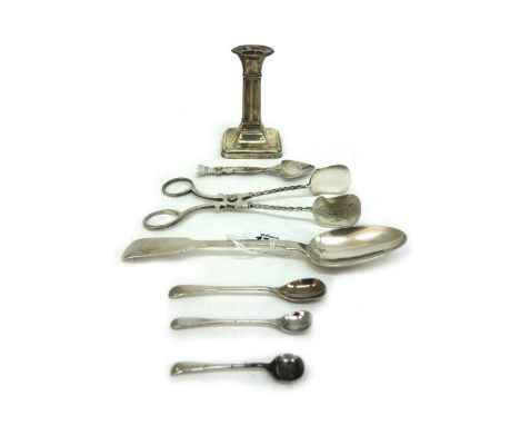 A George V silver dwarf candlestick, Sheffield 1910, 9.5cm high, a Victorian silver fiddle pattern dessert spoon, three silve