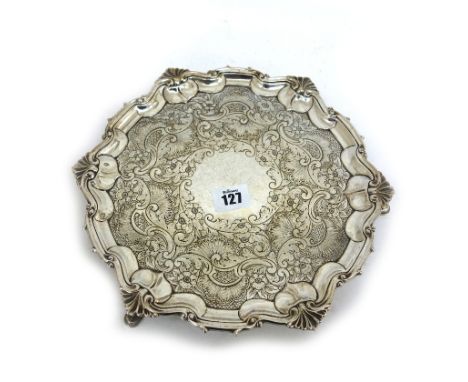 A George II style shaped circular silver salver, William Hutton & Sons, London 1908, chased with flowers, leaf scrolls, shell