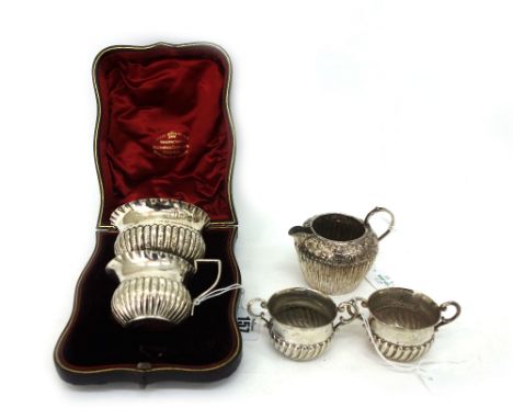 A Victorian silver sugar basin and cream jug, Vale Bros & Sermon, Birmingham 1893, embossed with lobes and flutes, crimped ri