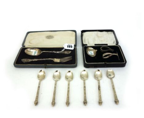 A George V foliate cast silver christening spoon and fork, Wakeley & Wheeler, London 1923 & 1925, in fitted case, a cased sil