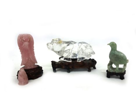 A Chinese carved rock crystal model of a resting buffalo, 20th century, 16cm wide on carved hardwood stand, a carved rose qua