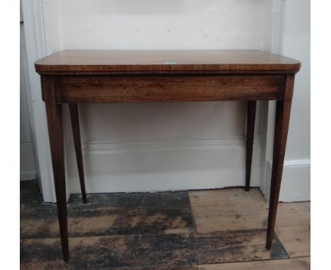 A George III mahogany boxwood banded and strung card table, the hinged fold over top on square tapered legs, 92cm wide. 