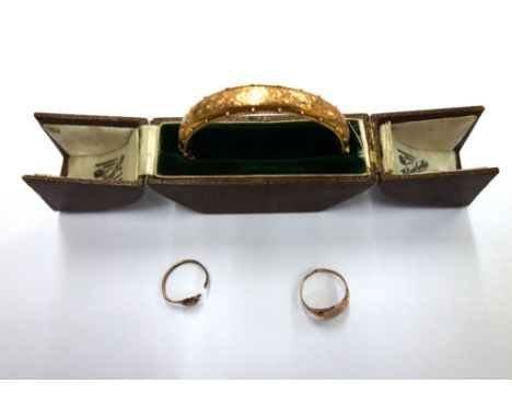 A 9ct hollow gold hinged bangle, Chester 1908, (cased), 10.6g and two gold rings (3).
