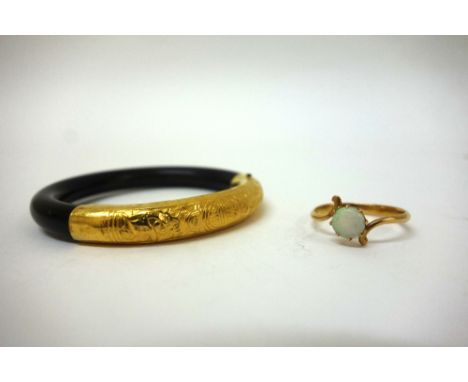 A child's gold and cabochon opal ring, unmarked, 1.9g gross and a Chinese horn and yellow metal bangle. (2)