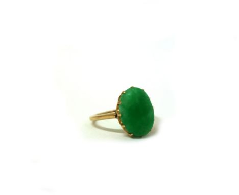 A gold and cabochon jade ring, unmarked, jade measures approximately 13.1 x 9.6 x 4.1mm, 3.6g gross. 