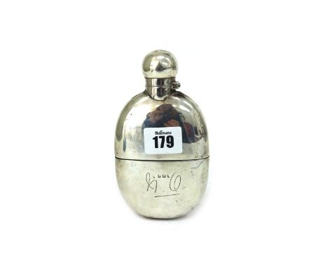 An Edwardian silver spirits hip flask, Birmingham 1909, curved to fit the pocket, with pull-off cup, 15cm long, 6ozs, initial