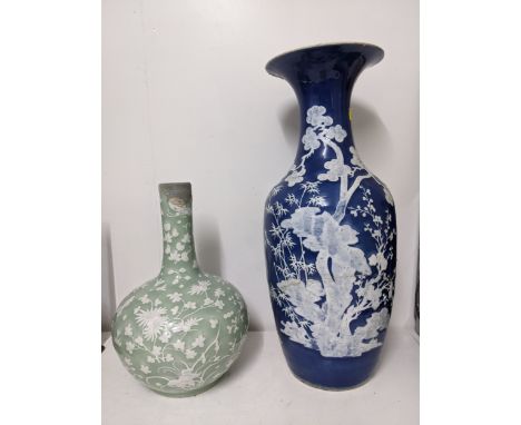 !9th century Chinese porcelain - a celadon slip glazed bottle vase decorated in white pate sur pate with  a butterfly and var