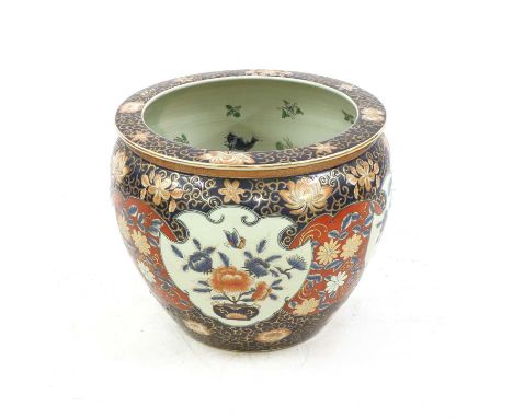 A mid 20th century Chinese ceramic fish bowl, boldly decorated with panels of flowers and butterflies and carp inside, 50cm d