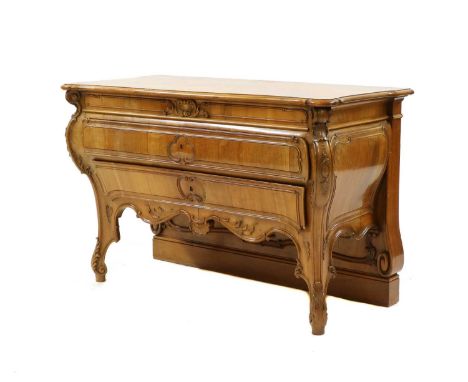 An Austrian walnut commode, 19th century, the serpentine outline top with two long drawers, shell and scroll carved decoratio