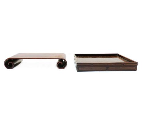 A Chinese wood stand, 20th century, the rectangular top with scroll ends, 37.5cm wide, 22.5cm deep, 7cm high, and a wood tray