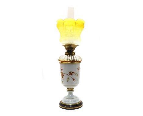 A Victorian painted glass oil lamp, the body decorated with birds and flowers, on a spreading circular base, fitted with a Me