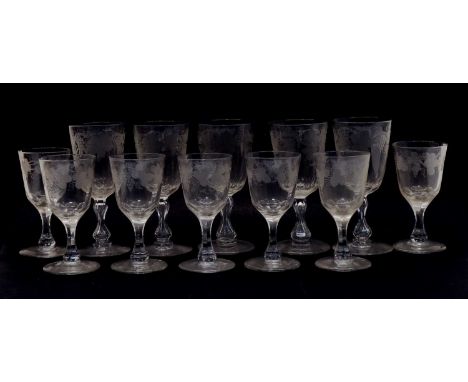 Glassware - a part matched suite of glasses, etched with vines, comprising: 9 champagne, 5, 7 and 8 wine glasses. 12.5 - 15.5