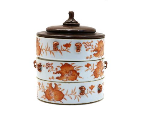 A Chinese iron-red stacking box, Republic period (1912-1949), of cylindrical form, painted with shou characters surrounded by