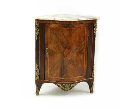 A French walnut bow front corner cupboard, the onyx top over a single door flanked by gilt metal mounted pilasters, 67cm wide