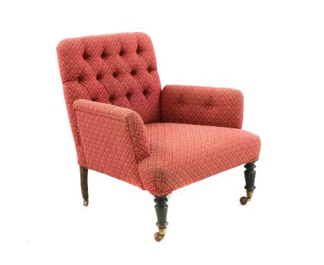 A small armchair, late 19th century, with a deep seat and buttoned back, upholstered in red floral fabric, raised on turned e